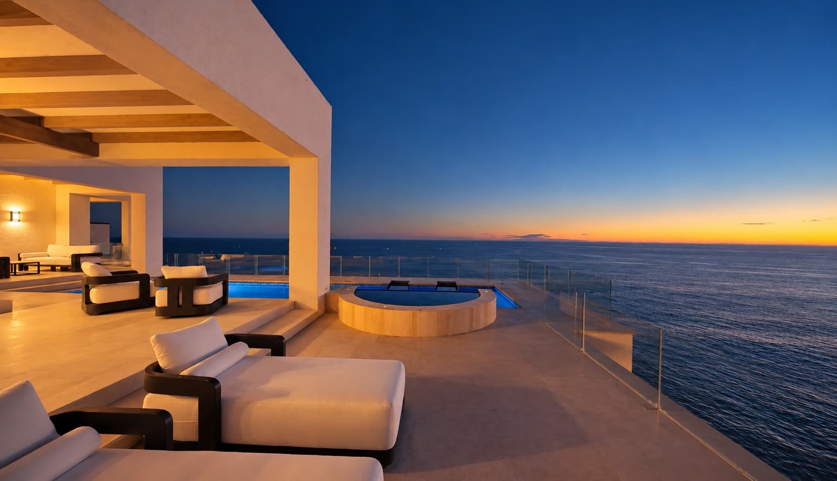 Sunset terrace with lounge chairs, jacuzzi, and Pacific ocean from Villa Siempre Azul